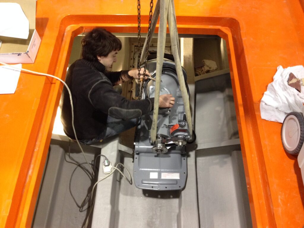 image of a yacht engine being dropped into place